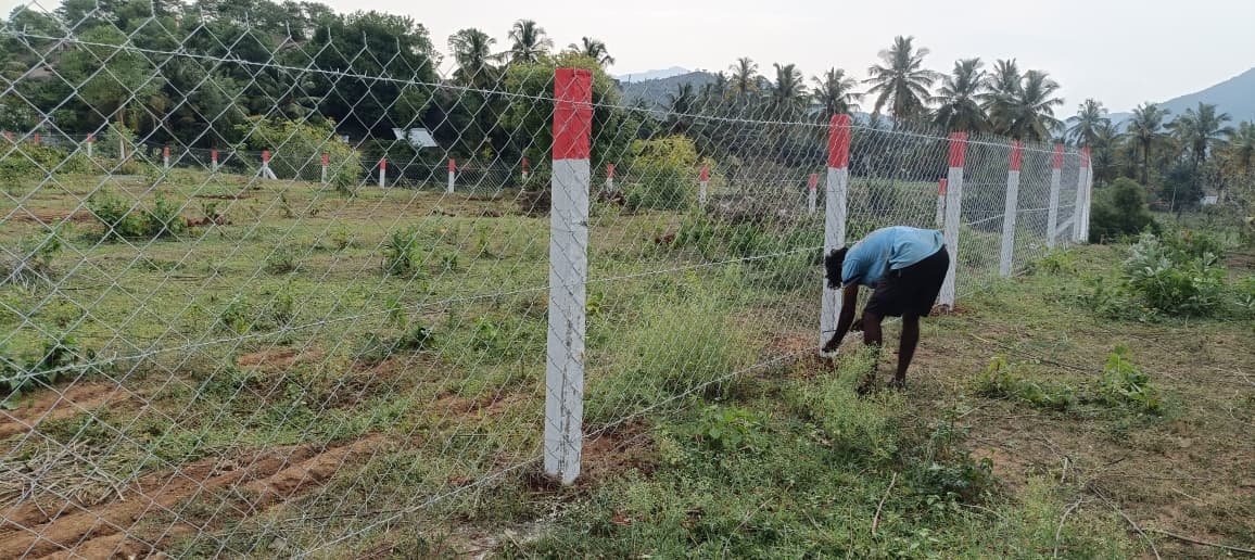 Worker fixing fence post, Chennai