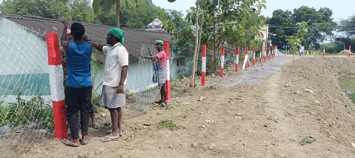 Worker with fence posts, Chennai