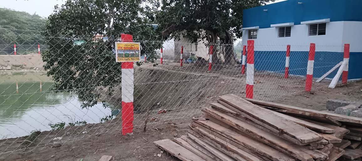 Red and white fence post with name board, Chennai